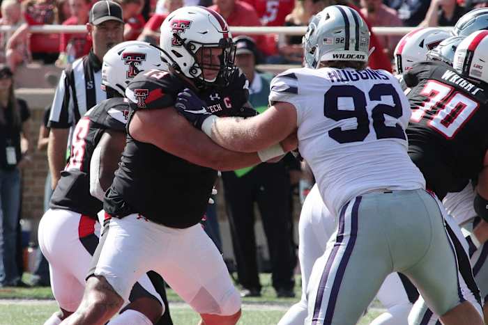 Oct 23, 2021; Lubbock, Texas, USA; Texas Tech Red Raiders offensive center Dawson Deaton (73) blocks Kansas State Wildcats defensive tackle Eli Huggins (92) in the second half at Jones AT&T Stadium. Mandatory Credit: Michael C. Johnson-USA TODAY Sports